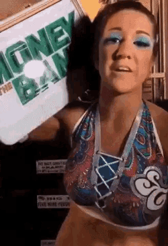a woman in a bikini is holding a money bag .