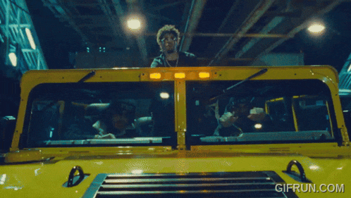 a gif from gifrun.com shows a man in a yellow truck