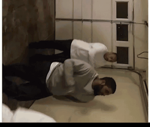 a couple of men standing next to each other in a garage
