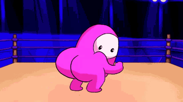 a pink cartoon character is standing in a boxing ring with a blue background