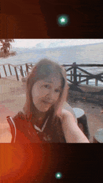 a woman taking a picture of herself with a green star in the background