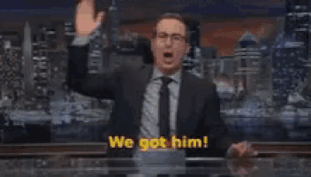 a man is standing in front of a sign that says we got him last week tonight