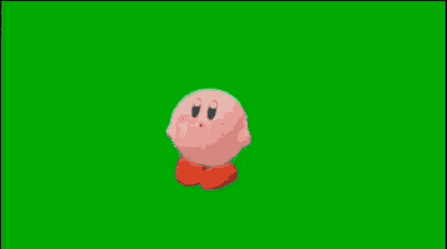 kirby from the video game super mario bros is flying through the air on a green screen .