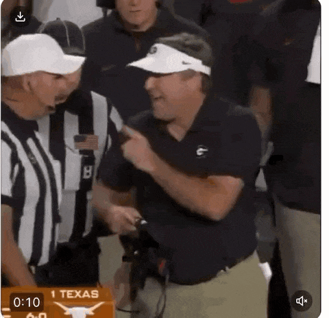 a man in a visor is pointing at a referee while standing in front of a sign that says texas .