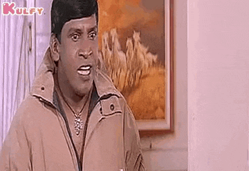 a man in a brown jacket is making a funny face in front of a picture of horses .