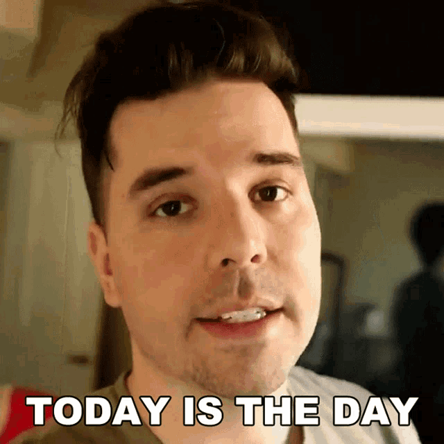a close up of a man 's face with the words today is the day behind him