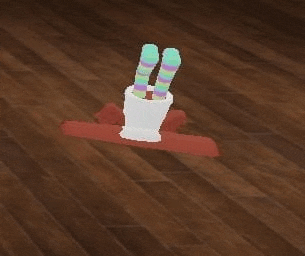 a pair of striped socks are sitting in a white cup on a wooden floor .