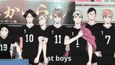 a group of boys are standing next to each other in a line wearing black jerseys .