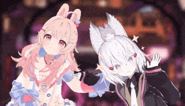 a girl with bunny ears is standing next to a boy with a cat on his head