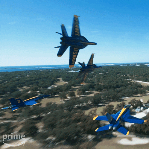 three u.s. navy jets flying over a golf course