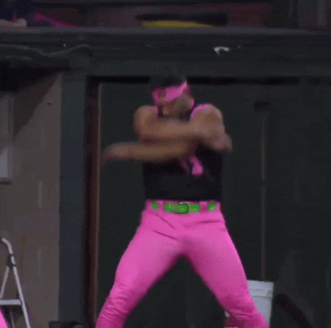 a man wearing a number 13 jersey and pink pants