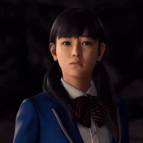 a girl in a school uniform with a bow tie looks at the camera