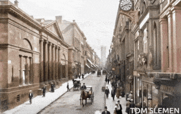 a black and white photo of a city street taken by tom slemen