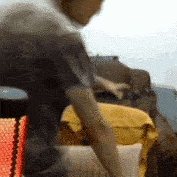 a blurry picture of a man sitting in a chair
