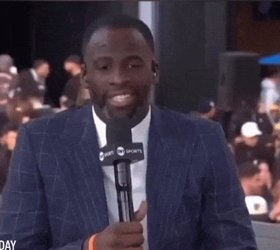 a man in a suit is holding a microphone that says world sports on it