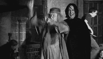 a black and white photo of a man and a woman dancing together in a room .