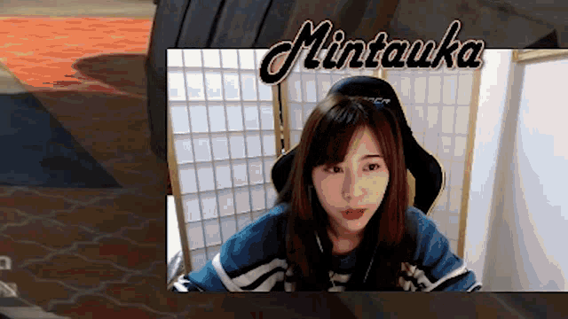 a girl is sitting in a chair with the name mintawa on the bottom