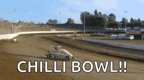 a race car is going down a dirt track with the words chilli bowl below it