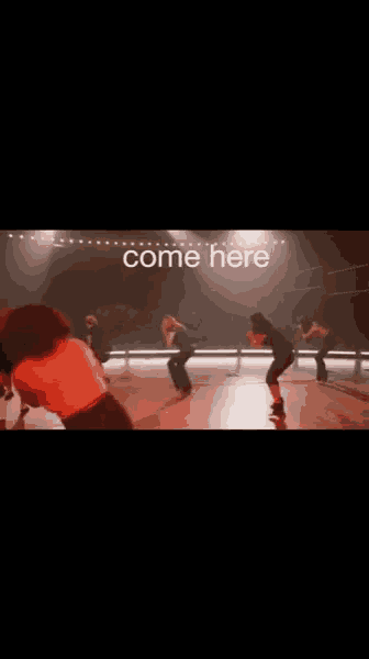 a group of people are dancing in a dark room with the words come here written on the bottom