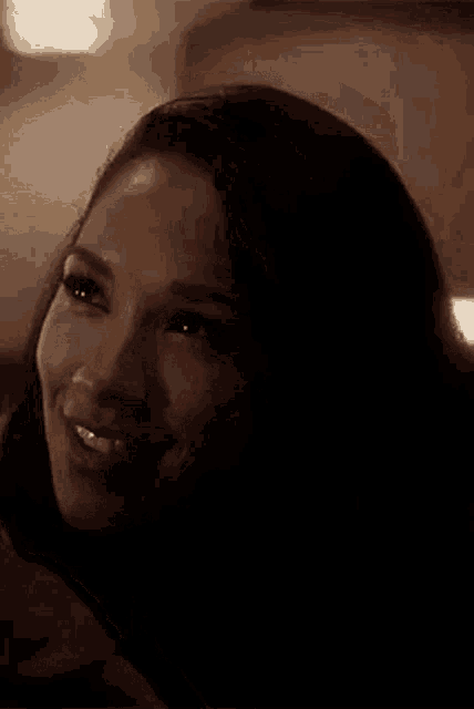 a close up of a woman 's face with a smile on her face .