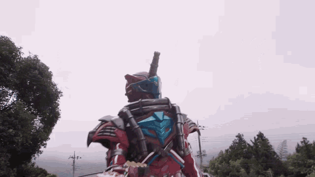 a man in a red and blue costume with a sword on his back