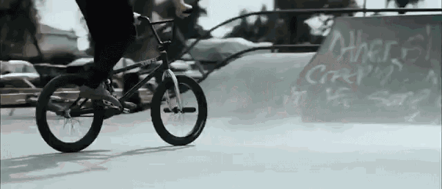 a person is riding a bmx bike on a ramp in front of a sign that says ' where ' on it