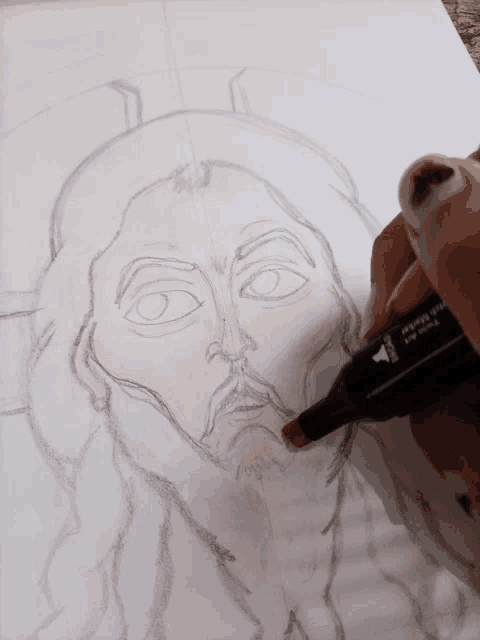 a person is drawing a picture of jesus with a marker that says ' twin tip ' on it