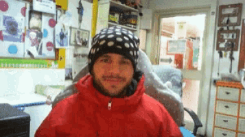 a man wearing a beanie and a red jacket