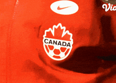 a close up of a red shirt with a canada logo on it