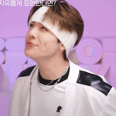 a man wearing a headband and a necklace looks up at something