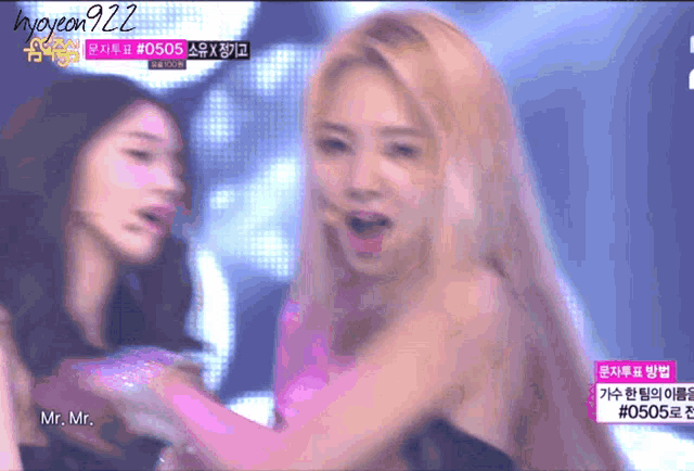 a woman with blonde hair is dancing on a stage with the name mr. mr. on the bottom right corner