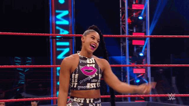 a woman in a wrestling ring with a sign that says main on it