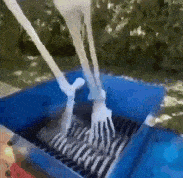 a skeleton 's feet are being shredded by a machine