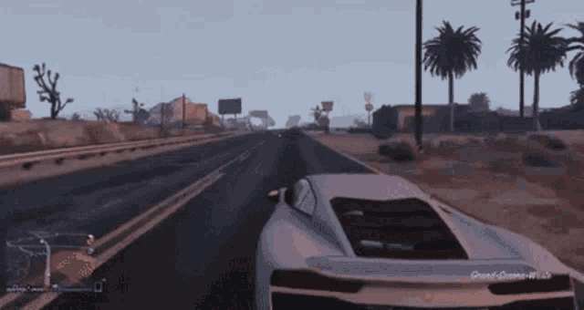 a video game screen shows a car driving down a highway
