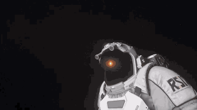 a man in a space suit is looking through binoculars in space .