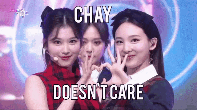 a group of girls are making a heart shape with their hands and the caption says chay does n't care .