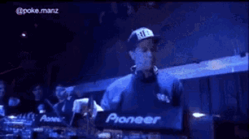 a man wearing a hat that says ny is playing music