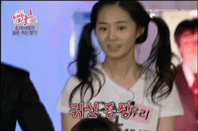 a woman with pigtails is wearing a white t-shirt that says ' a ' on it