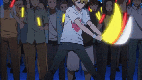 a man in a white shirt with a heart on it is holding a glowing yellow object in front of a crowd of people