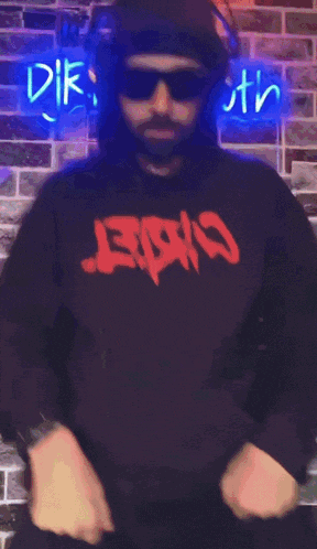 a man wearing sunglasses and a hoodie that says ' eek ' on it