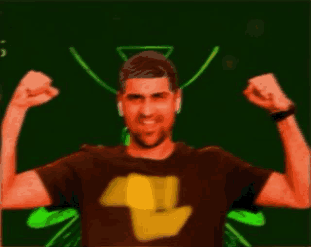 a man in a brown shirt is flexing his muscles .