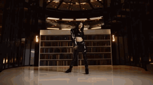 a woman in a sequined top is dancing in a library