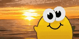 a cartoon lemon with big eyes and a smiling face is standing on a beach at sunset .