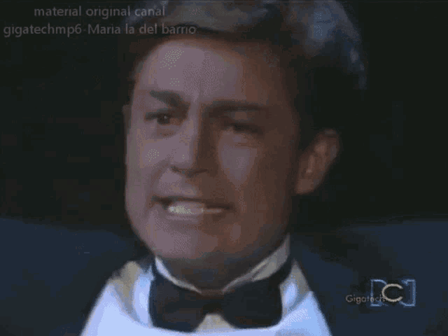 a man in a tuxedo and bow tie is being shown on a channel named gigatechmp6