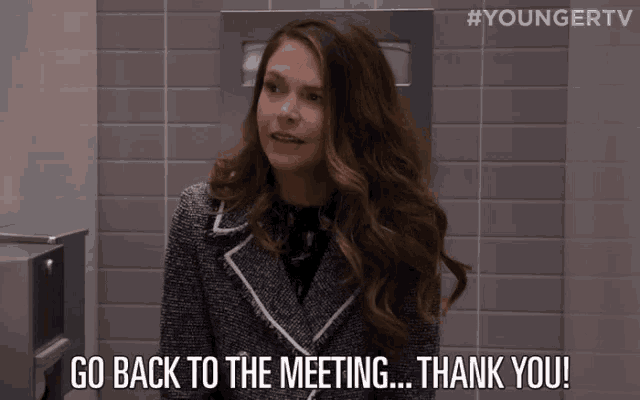 a woman says go back to the meeting thank you in a bathroom