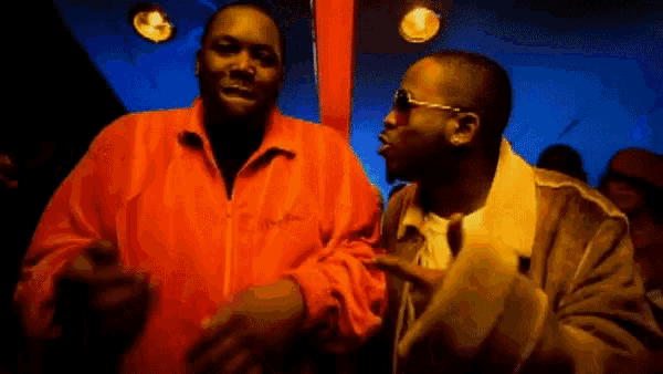 a couple of men are standing next to each other in a room .