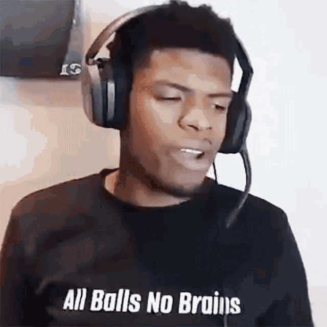 a man wearing headphones and a shirt that says all balls no brains