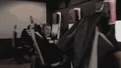 a man sits in a chair with his feet up in front of a computer