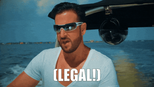 a man wearing sunglasses and a white shirt with the word legal written below him