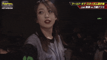 a woman stands in front of a screen that says #stardom